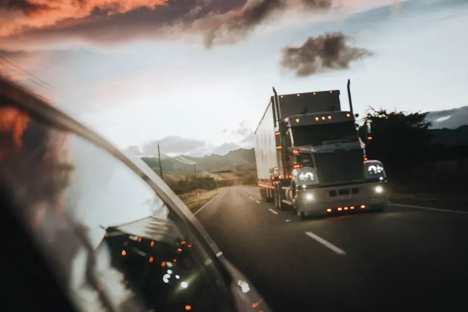 Freight truck travelling on a highway at sunset