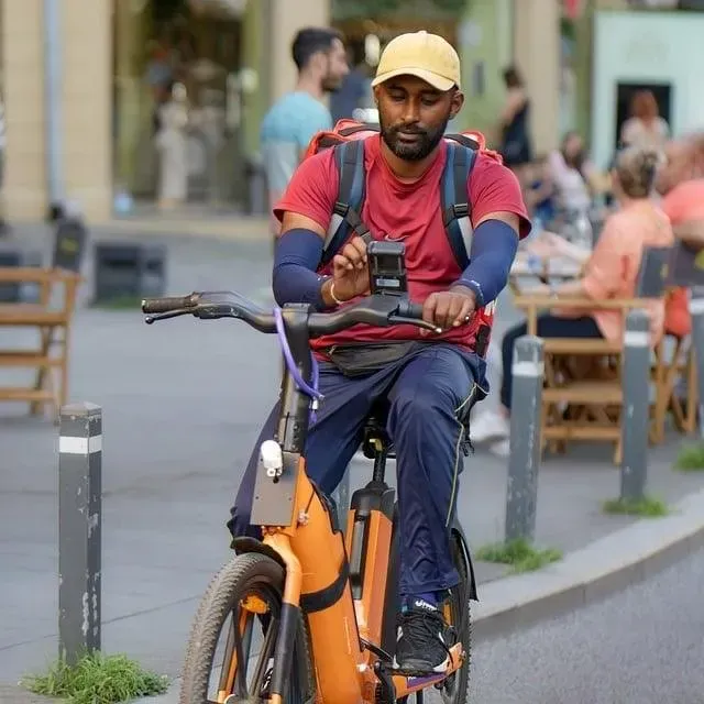 Delivery rider cycling along a city street