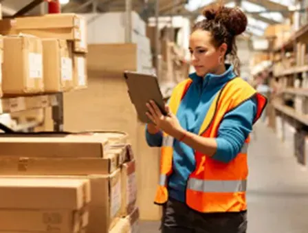 Warehouse worker comparing stock with information on a tablet