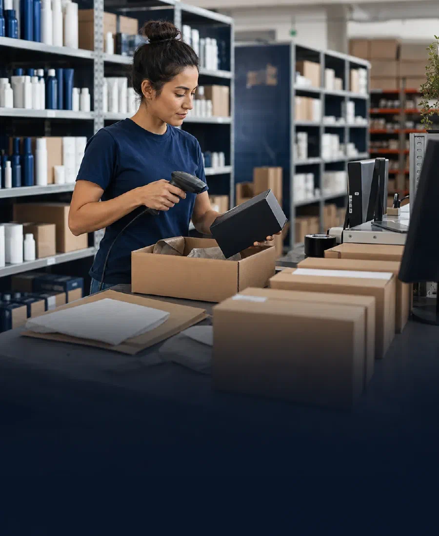 An associate scanning and packing an e-commerce order